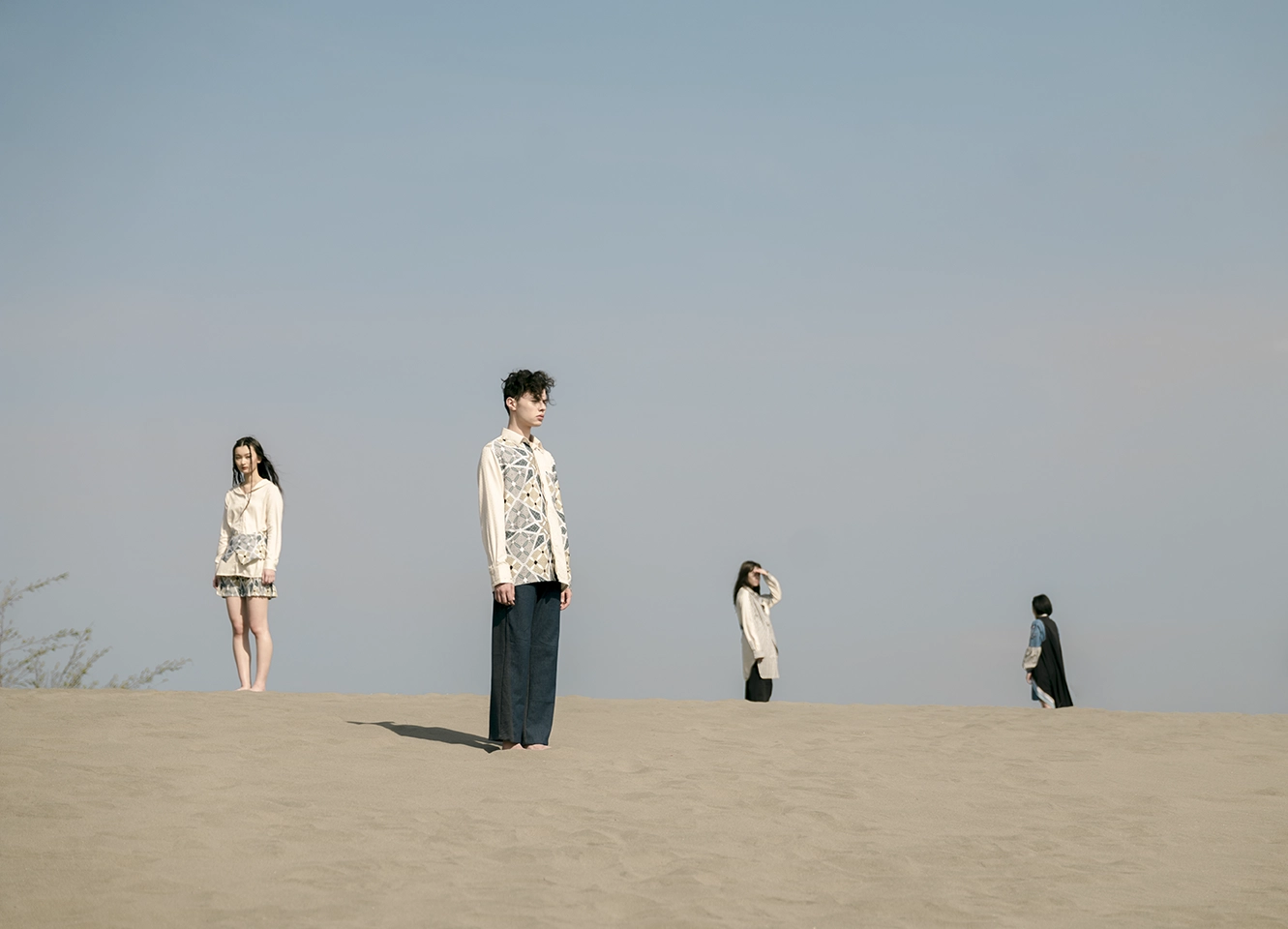 Kampong SS19 campaign with four figures across the landscape